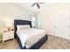 Tranquil bedroom featuring a tufted headboard, light walls, wood-look tile flooring, and ample natural light at 2978 Latitude Ln, Kissimmee, FL 34747