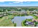 Scenic aerial view of a community with a golf course, with beautiful lakes winding through a residential neighborhood at 313 Sorrento Rd, Poinciana, FL 34759