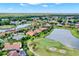 Aerial view showcasing a residential area with a golf course, ponds and meticulously landscaped lawns at 313 Sorrento Rd, Poinciana, FL 34759