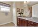 Bathroom vanity with marble countertop and dark wood cabinets at 313 Sorrento Rd, Poinciana, FL 34759