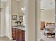 En-suite bathroom featuring granite counters and dark wood cabinets at 313 Sorrento Rd, Poinciana, FL 34759