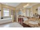 Bright bathroom featuring double vanity, soaking tub, and glass shower at 313 Sorrento Rd, Poinciana, FL 34759