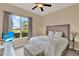 Cozy bedroom with plush bedding, natural light, and serene views of lush landscape at 313 Sorrento Rd, Poinciana, FL 34759