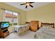 Comfortable guest bedroom with twin beds and natural light offers a cozy retreat at 313 Sorrento Rd, Poinciana, FL 34759