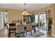 Elegant dining room with chandelier, patio access, and beautiful display cabinet is ideal for entertaining at 313 Sorrento Rd, Poinciana, FL 34759