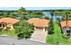 Beautiful single-story home with a manicured lawn, brick driveway, and a scenic waterfront view at 313 Sorrento Rd, Poinciana, FL 34759
