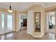 Bright and spacious foyer with tile flooring and decorative mirror at 313 Sorrento Rd, Poinciana, FL 34759