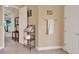Hallway featuring tile floors, open doors, and neutral paint at 313 Sorrento Rd, Poinciana, FL 34759