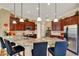 Spacious kitchen featuring granite countertops, stainless steel appliances, and pendant lighting at 313 Sorrento Rd, Poinciana, FL 34759