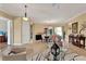 Open living area with dining space, stylish furnishings, and large windows at 313 Sorrento Rd, Poinciana, FL 34759
