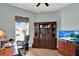 Home office with wood floors, desk, and a large built-in cabinet at 313 Sorrento Rd, Poinciana, FL 34759