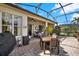 The covered lanai has stone floors, ceiling fans, and a BBQ for relaxing and entertaining outdoors at 313 Sorrento Rd, Poinciana, FL 34759