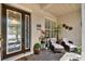 Inviting front porch area featuring comfortable seating and decorative plants at 313 Sorrento Rd, Poinciana, FL 34759