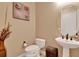 Powder room featuring a pedestal sink and decoratively painted walls at 313 Sorrento Rd, Poinciana, FL 34759