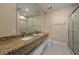 Bathroom featuring double vanity with granite countertops and a tiled glass shower at 3228 Brasilia Ave, Kissimmee, FL 34747