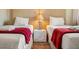 Inviting bedroom with two beds, warm lighting, and clean aesthetic, offering a comfortable retreat at 3228 Brasilia Ave, Kissimmee, FL 34747