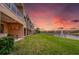 Backyard with a covered patio, outdoor kitchen, and a view of the water and neighborhood at 3228 Brasilia Ave, Kissimmee, FL 34747