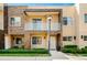 Charming two-story townhome with a decorative stone facade, balcony and well-maintained landscaping at 3228 Brasilia Ave, Kissimmee, FL 34747