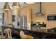Stylish kitchen featuring a breakfast bar, stainless steel appliances, and modern lighting fixtures at 3228 Brasilia Ave, Kissimmee, FL 34747
