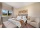 Bright bedroom with a large window, neutral tones, a king bed, and decorative art at 3228 Brasilia Ave, Kissimmee, FL 34747