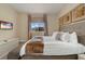 Bright bedroom with a king bed, TV, and window with a view of the neighborhood at 3228 Brasilia Ave, Kissimmee, FL 34747