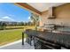 Covered patio includes a complete outdoor kitchen with a dining table and a beautiful water view at 3228 Brasilia Ave, Kissimmee, FL 34747