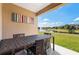 Covered patio with dining table, colorful art, and a view of the water feature at 3228 Brasilia Ave, Kissimmee, FL 34747
