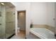 Bright bathroom features separate shower and tub with neutral tile and fixtures at 3536 Moss Pointe Pl, Lake Mary, FL 32746