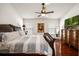 Spacious bedroom with hardwood floors, ceiling fan, and abundant natural light at 3536 Moss Pointe Pl, Lake Mary, FL 32746