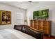 Comfortable bedroom with hardwood floors, dresser and large decorative artwork at 3536 Moss Pointe Pl, Lake Mary, FL 32746
