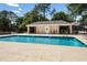 Inviting community pool area with a shaded pavilion, offering a refreshing recreational space for residents at 3536 Moss Pointe Pl, Lake Mary, FL 32746