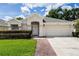 Charming single-story home featuring a well-manicured lawn, brick walkway, and a two-car garage at 3536 Moss Pointe Pl, Lake Mary, FL 32746