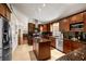 Stylish kitchen with dark wood cabinets, granite countertops, stainless steel appliances, and center island at 3536 Moss Pointe Pl, Lake Mary, FL 32746