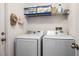 Efficient laundry area equipped with Samsung washer and dryer, plus storage shelves for organization at 3536 Moss Pointe Pl, Lake Mary, FL 32746