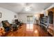 Bright living room with shiny hardwood floors, comfortable seating, and sliding glass door access at 3536 Moss Pointe Pl, Lake Mary, FL 32746