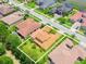 Overhead view of a residential property showcasing its tile roof, lawn, and landscaping in a community setting at 4120 Juliana Lake Dr, Auburndale, FL 33823