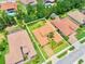 Aerial view of a single-Gathering home featuring a tile roof, well-maintained landscaping, and a manicured lawn at 4120 Juliana Lake Dr, Auburndale, FL 33823