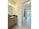 View of the bathroom vanity featuring granite countertops and a decorative light fixture at 4120 Juliana Lake Dr, Auburndale, FL 33823
