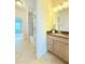 Well-lit bathroom with granite countertops, tile flooring, and tub with shower at 4120 Juliana Lake Dr, Auburndale, FL 33823