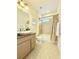 Stylish bathroom featuring granite vanity, modern sink, and shower-tub combo with decorative tile at 4120 Juliana Lake Dr, Auburndale, FL 33823
