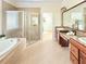 Primary bathroom featuring a soaking tub, glass shower, and double sink vanity at 4120 Juliana Lake Dr, Auburndale, FL 33823