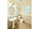 Well-lit powder bathroom with pedestal sink and neutral tile at 4120 Juliana Lake Dr, Auburndale, FL 33823