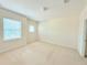 Bright and airy bedroom featuring two large windows and neutral walls and carpeting at 4120 Juliana Lake Dr, Auburndale, FL 33823