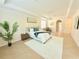 Bright bedroom offers a tray ceiling, white rug, neutral decor, and archway views at 4120 Juliana Lake Dr, Auburndale, FL 33823