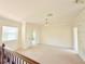 Bright upstairs bonus room with neutral walls, carpet, crown molding, and natural light from a window at 4120 Juliana Lake Dr, Auburndale, FL 33823