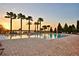 Community pool surrounded by palm trees and lounge chairs, offering a tranquil setting for residents at 4120 Juliana Lake Dr, Auburndale, FL 33823