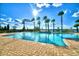 Sparkling community pool with a brick patio, palm trees, and clear blue skies, perfect for relaxation at 4120 Juliana Lake Dr, Auburndale, FL 33823