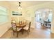 Charming dining area featuring a round table, wainscoting, and view of the foyer at 4120 Juliana Lake Dr, Auburndale, FL 33823