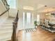 Inviting foyer with staircase, dining room, hardwood floors, and plenty of natural light at 4120 Juliana Lake Dr, Auburndale, FL 33823