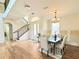 Light-filled foyer boasts a staircase and dining area, creating an inviting entryway at 4120 Juliana Lake Dr, Auburndale, FL 33823